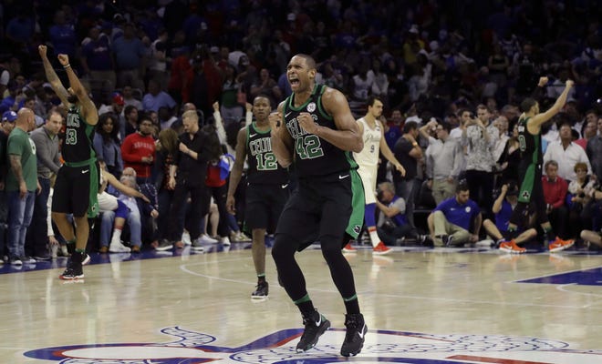 Al Horford (42) celebrates after the Celtics defeated the Philadelphia 76ers, 101-98, in overtime on Saturday to take a 3-0 series lead in their second-round playoff series. [Matt Slocum/AP]