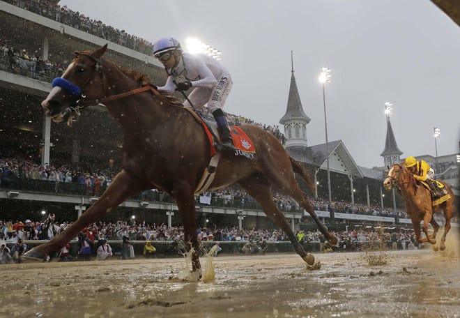 Mike Smith rides Justify to victory during the 144th running of the Kentucky Derby at Churchill Downs Saturday in Louisville, Ky. [Morry Gash/AP]