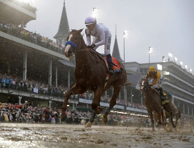 Mike Smith rides Justify to victory during the 144th running of the Kentucky Derby horse race at Churchill Downs Saturday in Louisville, Ky.