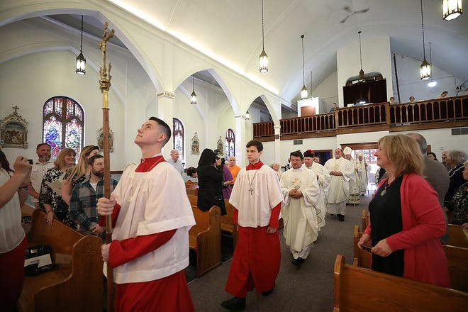 The celebrants center the Church of the Holy Cross in Central Falls for a ceremony on Saturday to celebrate the 100th anniversary of the church's first Mass, in 1918. [The Providence Journal / Glenn Osmundson]