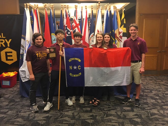 Jonathan Shauf, John Kim, Turner White, Carter Plaster, Matilda Ziegler and Pierce Robinson hold the state flag after their win at the National History Bowl and Bee in Washington, D.C. [Special to The Star]