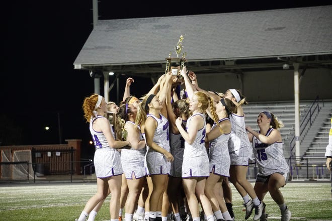 The Mount Union women's lacrosse team celebrates the OAC championship after defeating Capital 11-8 on Saturday night. (Photo courtesy of Brent Greenberg)