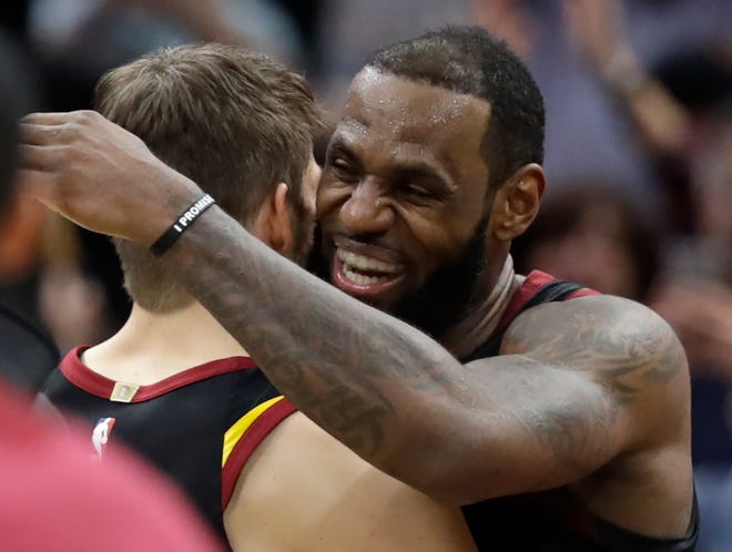 Cleveland Cavaliers' LeBron James, right, hugs Kyle Korver after hitting the game-winning shot to defeat the Toronto Raptors 105-103 in Game 3 of an NBA basketball second-round playoff series, Saturday, May 5, 2018, in Cleveland. (AP Photo/Tony Dejak)