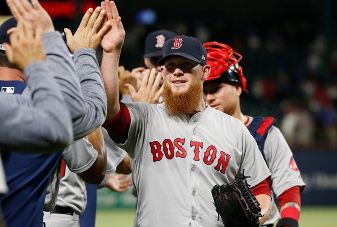 Boston closer Craig Kimbrel is congratulated by teammates after the Red Sox beat the Texas Rangers on Saturday. Kimbrel notched his 300th career save.