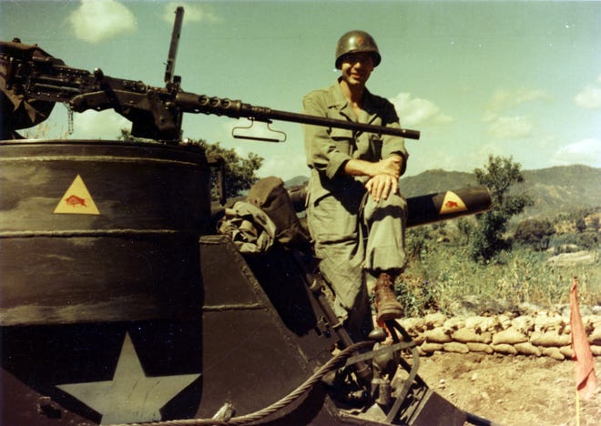 Master Sgt. Bob Steffy of Hartville and a member of Battery C, 987th Armored Field Artillery Battalion, poses on the front of a M7 105 mm self-propelled howitzer in the IX Corps Area during the fall of 1951. The 987th's logo, a yellow triangle with a red bull, can be seen on the vehicle body and gun tube. (Ohio Army National Guard Historical Collections)