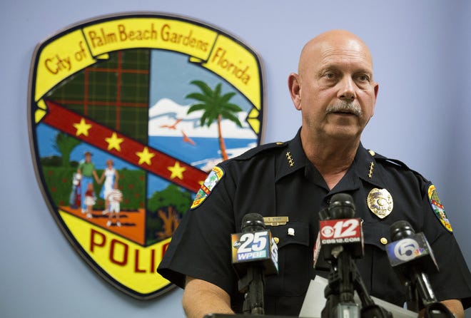 In this photo taken on Tuesday, Oct. 20, 2015, Palm Beach Gardens Chief Stephen Stepp reads a statement to the media about the shooting death of Corey Jones by his police officer Nouman Raja, at the Palm Beach Gardens Police Department, in Palm Beach Gardens, Fla. (Greg Lovett/The Palm Beach Post via AP)