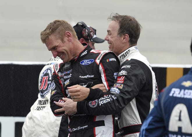 Clint Boyer, left, and Kevin Harvick, right, joke around during a weather delay during the NASCAR Cup series auto race, Sunday, May 6, 2018, at Dover International Speedway in Dover, Del. (AP Photo/Nick Wass)