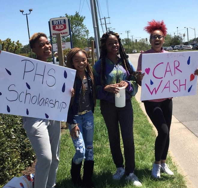 Three teens and a mentor from the Cupcakes & Conversation organization raise money for the nonprofit's annual scholarship via car wash on April 29, 2018. [Contributed photo]