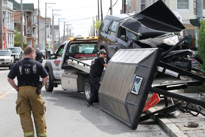 An SUV is towed aftre crashing into a bus stop at Webster and Union avenues in Providence on Monday. [The Providence Journal/Bob Breidenbach]