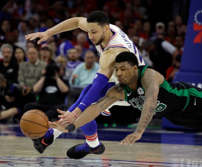 Celtics guard Marcus Smart, right, and Philadelphia 76ers guard Ben Simmons chase after a loose ball during Monday's Game 4 in Philadelphia. [The Associated Press]