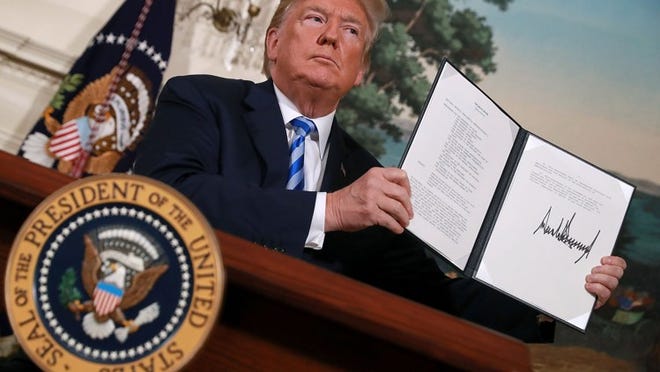 U.S. President Donald Trump holds up a memorandum that reinstates sanctions on Iran after he announced his decision to withdraw the United States from the 2015 Iran nuclear deal in the Diplomatic Room at the White House on Tuesday. After two and a half years of negotiations, Iran agreed in 2015 to end its nuclear program in exchange for Western countries, including the United States, lifting decades of economic sanctions. Since then international inspectors have not found any violations of the terms by Iran. (Photo by Chip Somodevilla/Getty Images)