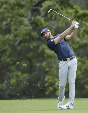 Dustin Johnson hits a shot to the first hole during the fourth round at the Masters golf tournament April 8 in Augusta, Ga. Johnson has been No. 1 for 15 months and needs his best finish at The Players Championship to have a chance to stay there. [AP Photo/David J. Phillip, file]