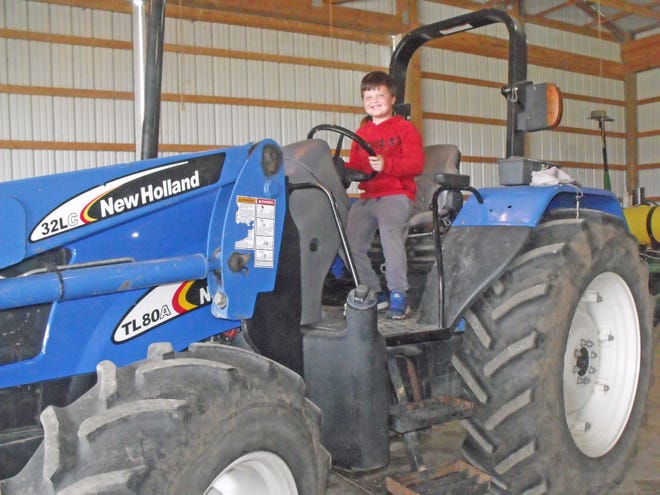 Braylon tried his hand at climbing upon and “driving” a big tractor during the annual Project R.E.D. held at the BACC FFA Land Lab. JULIA BARATTA PHOTO