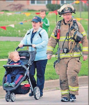 Lakeland Firefighter Alex Lewis, his wife Sara and son Owen at a past year’s event. FILE PHOTO