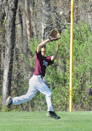 Tiverton High right fielder Damien DeGala makes a running catch near the foul line during Tuesday's home game against Wheeler. [Herald News Photo|Dave Souza]