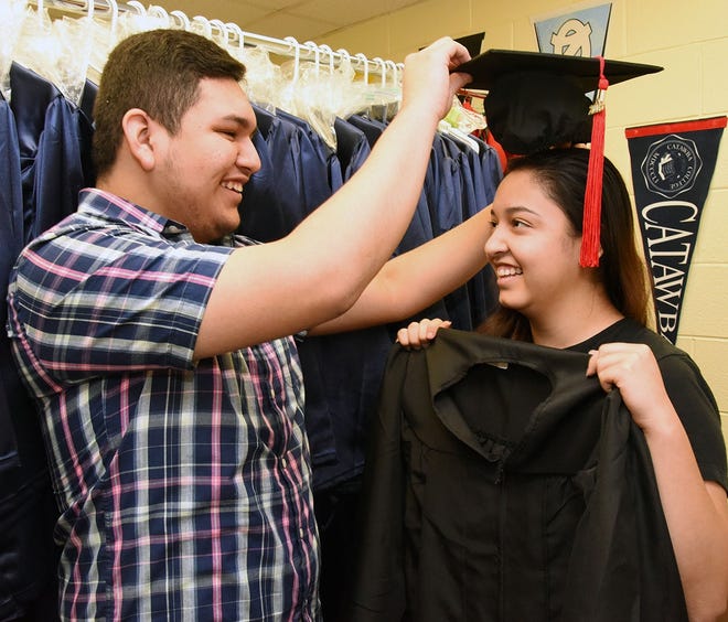 Lenoir County Early College High School seniors Marcos Bautista and Lizeth Rodriguez-Servin goof around with cap and gown in anticipation of their high school graduation Thursday evening. Both will also receive associate degrees at Lenoir Community College’s commencement Friday night. [Submitted photo]