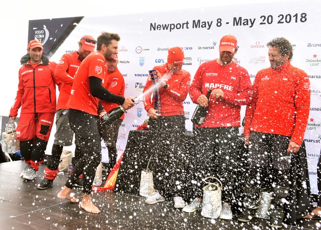 The MAPFRE team celebrates its win of the eighth leg of the Volvo Ocean Race on the podium Tuesday morning at Fort Adams State Park. [DAVE HANSEN/STAFF PHOTOGRAPHER]