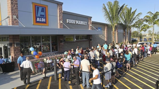 People line up before the grand opening of the new Aldi store on State Road 7 in Royal Palm Beach in 2015. The store sits next to the company’s massive distribution warehouse. (Lannis Waters / The Palm Beach Post)