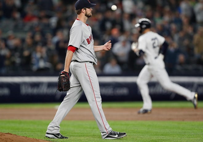 Red Sox pitcher Drew Pomeranz tosses the ball up in frustration after allowing a solo home run to Giancarlo Stanton, who is rounding the bases, in the fourth inning.