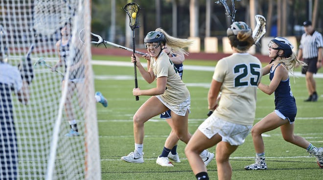 Saint Stephen's Falcons' Baylee Barker scores against the Out-of-Door Thunder during the Class 1A-District 17 girls lacrosse championship game Friday evening, April, 20, 2018, at Saint Stephen's field. Barker was named to the All-District 17 first team. [Herald-Tribune staff photo / Thomas Bender]