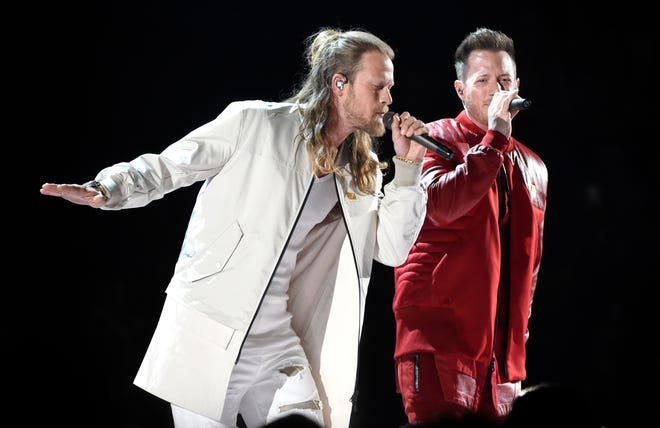 FILE - In this April 15, 2018 file photo, Tyler Hubbard, right, and Brian Kelley, of Florida Georgia Line, perform "Meant to Be" at the 53rd annual Academy of Country Music Awards in Las Vegas. The duo, along with Carrie Underwood and Jason Aldean are the leading nominees for the CMT Music Awards with four each. Little Big Town, who are nominated for three awards, will host the show, which airs on June 6 at 8 p.m. Eastern on CMT. (Photo by Chris Pizzello/Invision/AP)