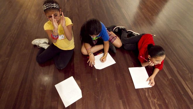 Fourth-graders from Perez Elementary School create artwork as part of a partnership between the Blanton Museum of Art and Badgerdog Literary Publishing in 2012.