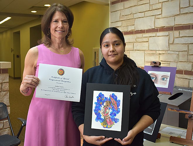 U.S. Rep. Cheri Bustos, left, presents Andrea Avalos of Monmouth-Roseville High School with her runner-up certificate for the Congressional Art Competition.