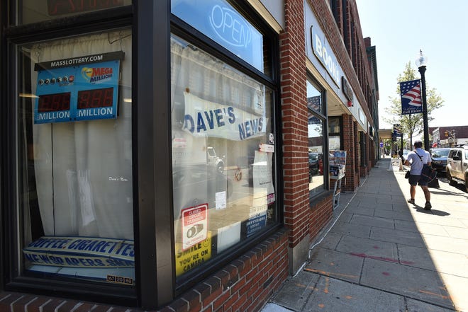 The "open" sign and lottery numbers are dark at the former Dave's News, at 274 South Main Street. [Herald News Photo | Jack Foley]