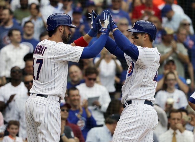 Chicago Cubs' Anthony Rizzo, right, celebrates with Kris Bryant after hitting a three-run home run against the Miami Marlins in the third inning of a baseball game Wednesday, May 9, 2018, in Chicago. (AP Photo/Nam Y. Huh)
