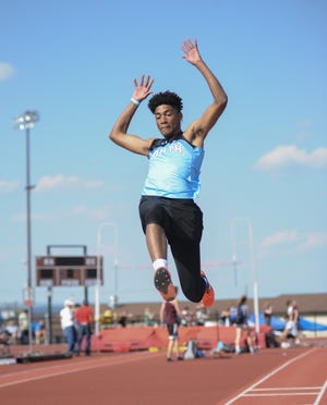 East Stroudsburg North's Justin Miller leaps into the air during the finals for the long jump at the EPC track and field championship on Wednesday in Whitehall. Miller took the gold with his jump. [KEITH R. STEVENSON/POCONO RECORD]