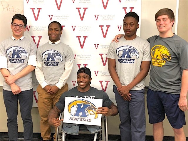 Three Cleveland Villa Angela St. Josephs wrestlers signed national letters of Intent to wrestle for Kent State Tuscarawas at the high school in Cleveland. Pictured are: Ray Velez (left), King Seyou, Kent State Tuscarawas wrestler Zion Clark, Carl Chaney and Kent State Tuscarawas wrestler Austin Bailey.