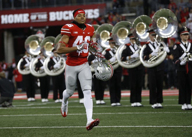 Cin'Quan Haney runs onto the field for Senior Day against Illinois on Nov. 18. Later that day, the cornerback would take part in his one and only play as a Buckeye, and it was almost a memorable one.