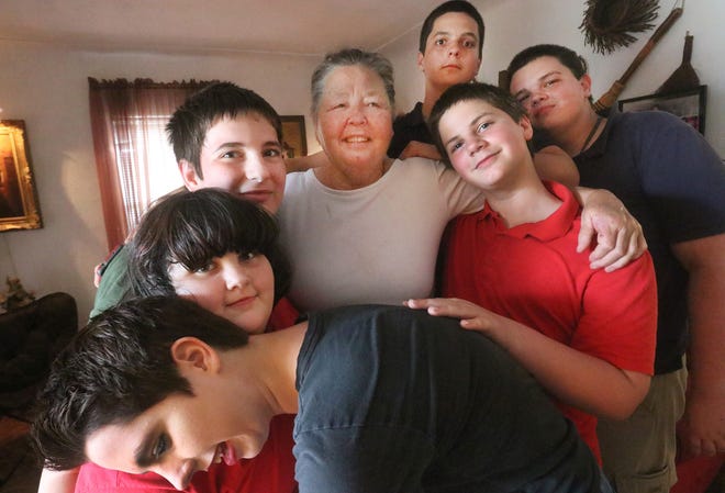 Glenda Wilson's six grandchildren swarm in for a group hug in the living room of their Ormond Beach home. Wilson adopted, from left, Autumn, 21, Skyler, 10, Tyler, 14, Dylan, 16, Adrian, 18, and Logan, 12, after their mother dropped them off eight years ago and moved out of state without warning. “Point out to me which one you wouldn’t take,” 

Wilson recalled saying in 2010 to the Florida Department of Children and Families workers who came to take her grandchildren into foster care. [News-Journal/David Tucker]