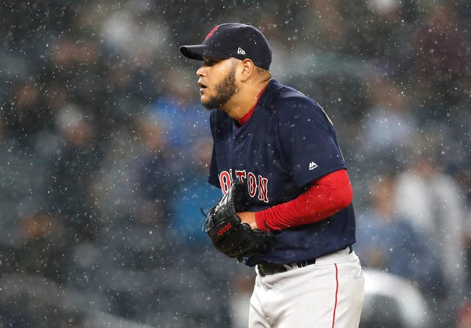 Boston Red Sox starting pitcher Eduardo Rodriguez reacts as rain starts to fall during the fourth inning of the team's baseball game against the New York Yankees in New York, Thursday, May 10, 2018. (AP Photo/Kathy Willens)