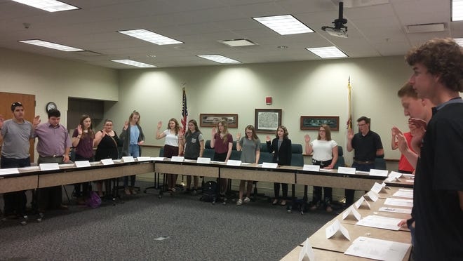 CHRIS KAERGARD / JOURNAL STAR

Washington Community High School students are sworn in by City Clerk Pat Brown as part of a government-for-a-day program on Thursday morning.