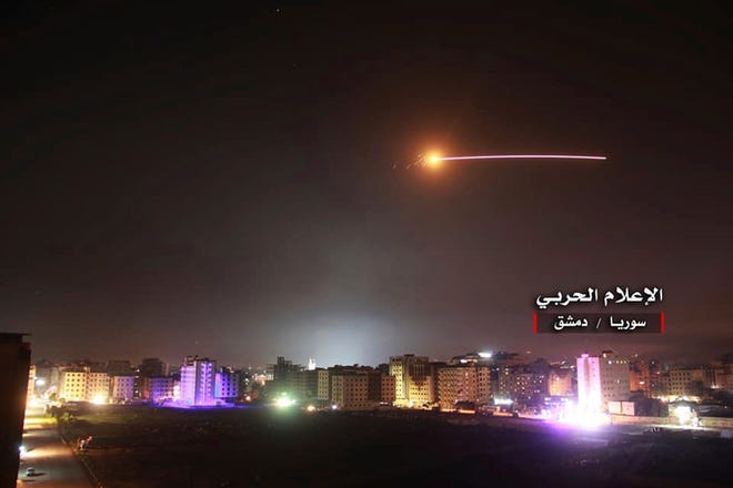This photo provided early Thursday, May 10, 2018, by the government-controlled Syrian Central Military Media, shows missiles rise into the sky as Israeli missiles hit air defense position and other military bases, in Damascus, Syria. The Israeli military on Thursday said it attacked "dozens" of Iranian targets in neighboring Syria in response to an Iranian rocket barrage on Israeli positions in the Golan Heights, in the most serious military confrontation between the two bitter enemies to date.