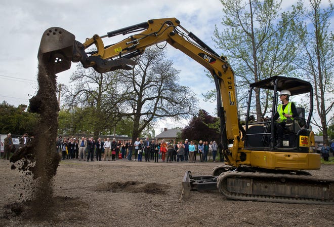 Eugene Ballet artistic director Toni Pimble turns the ceremonial first spade of earth in an excavator as the Eugene Ballet Company breaks ground on the new Midtown Arts Center at E. 16th Ave. and Pearl St. [Brian Davies/The Register-Guard] - registerguard.com