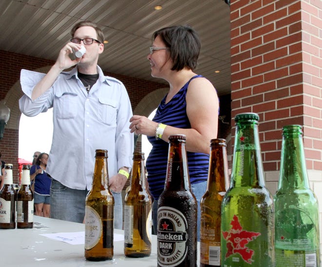 Andy and Danaye Amon are seen taste testing a beer during a past Ale on the Border event in Fort Smith. This year's Ale on the Border will be held from 6-10 p.m. May 19 at Chaffee Crossing, 7313 Terry St., and will feature craft beer, food trucks and musical performances by The Crumbs, Oreo Blue and Mr. Cabbagehead and the Screaming Radishes. [TIMES RECORD FILE PHOTO]
