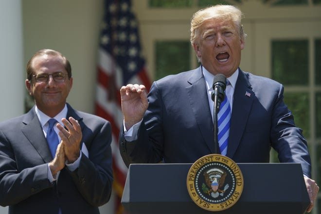 President Donald Trump speaks during an event about prescription drug prices with Health and Human Services Secretary Alex Azar, left, in the Rose Garden of the White House in Washington, Friday, May 11, 2018. (AP Photo/Carolyn Kaster)