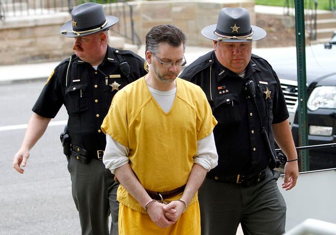 Shawn Grate is escorted into the Ashland County Courthouse by Ashland County Sheriff Office Deputy Shannon Mahoney and Sgt. Brian Martin Friday for the evidentiary hearing to determine Grate's guilt on two specifications related to the kidnapping of Stacey Stanley. 

Tom E. Puskar, Times-Gazette.com