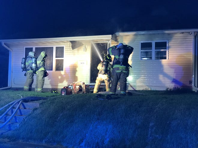 Burlington firefighters put water on flames inside a house at 615 N. Garfield Ave. in Burlington. The fire, reported just before midnight Thursday, caused extensive damage. No one was home when fire crews arrived, and there were no injuries. [Craig Neises/thehawkeye.com]