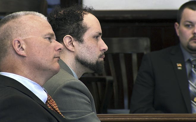 In this still image from video, Luc Tieman, center, and his lawyer Stephen Smith, left, listen inside a courtroom where Tieman was sentenced to 55 years, Friday, May 11, 2018, in Somerset County Superior Court in Skowhegan, Maine. Tieman, who was convicted in April of killing his wife, did not address the court. [Spencer Roberts/WABI-TV via AP]
