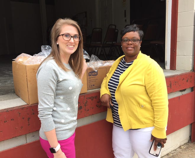 Dinwiddie Elementary School teachers Jordan Reekes. left, and Lisa Thomas, right, had their students bake bread to give to the Hope Center in Petersburg. [Contributed Photo]
