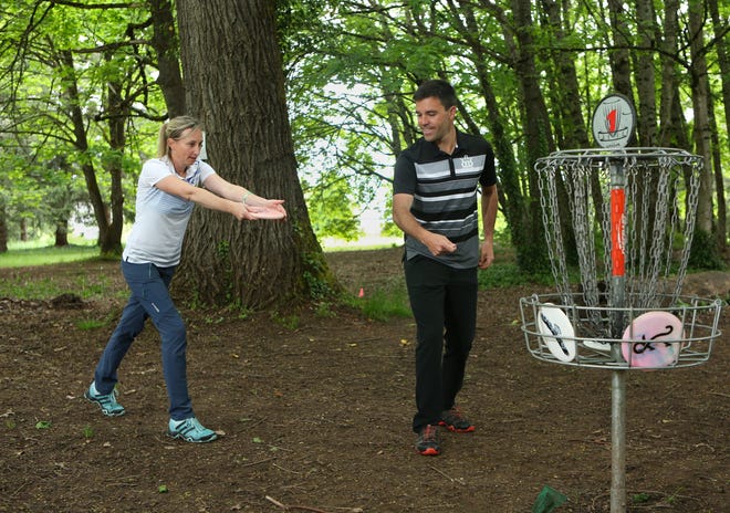 Zoe AnDyke and Dustin Keegan are both Eugene pro disc golfers who train and tour together. Here they discuss technique at the Alton Baker Park disc golf course. AnDyke is ranked 17th in the world and Keegan is ranked in the top 5 in Oregon. [Kelly Lyon/The Register-Guard]