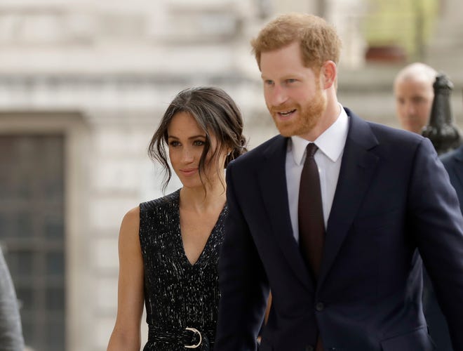 FILE - In this file photo dated Monday, April 23, 2018, Britain's Prince Harry and his fiancee Meghan Markle attend a Memorial Service to commemorate the 25th anniversary of the murder of black teenager Stephen Lawrence at St Martin-in-the-Fields church in London. Now with only a week until the May 19 wedding of Prince Harry and Meghan Markle, a party atmosphere is developing in the English city of Windsor, with tens of thousands of visitors expected in the city on the couple’s wedding day. (AP Photo/Matt Dunham, FILE)