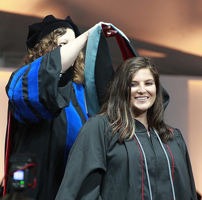 Stephanie Capuzzo is all smiles after receiving her academic hood at Bridgewater State University Graduate Convocation on Thursday, May 10, 2018. [Dave DeMelia/The Enterprise]