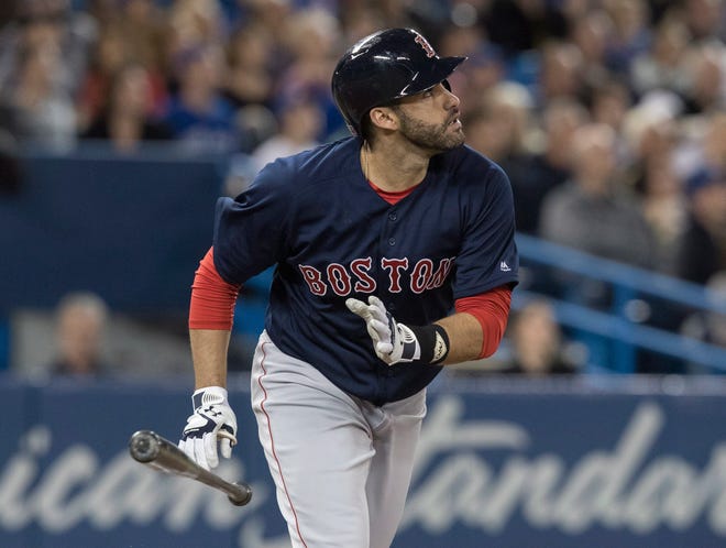 Boston's J.D. Martinez just misses hitting a home run as the ball lands on top of the wall and winds up a third-ining double in Toronto. [The Associated Press]