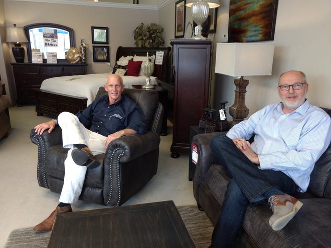Brad Palmer, left, and Kevin Rule relax inside the Sleep Shoppe and Furniture Gallery in downtown Hutchinson. Rule has purchased the 38-year-old business from Palmer. [Courtesy photo / Sleep Shoppe]