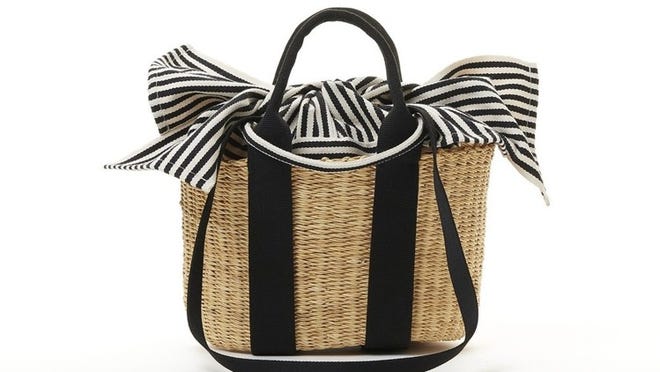 Straw Muun bag with black and white striped detachable lining.