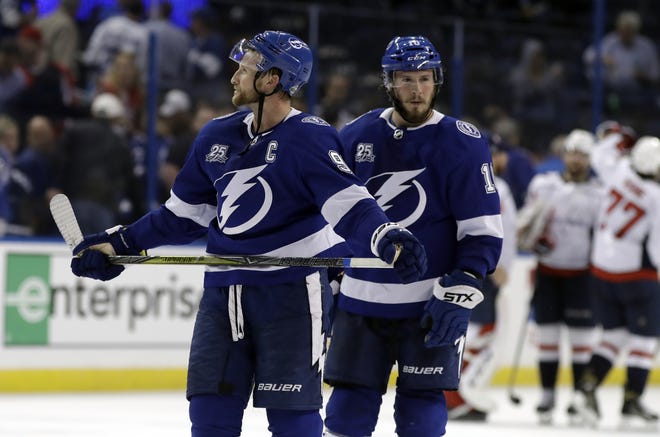 Tampa Bay Lightning center Steven Stamkos (91) and center J.T. Miller (10) leave the ice after losing 4-2 to the Washington Capitals in Game 1 of the Eastern Conference finals. [AP PHOTO/CHRIS O'MEARA]